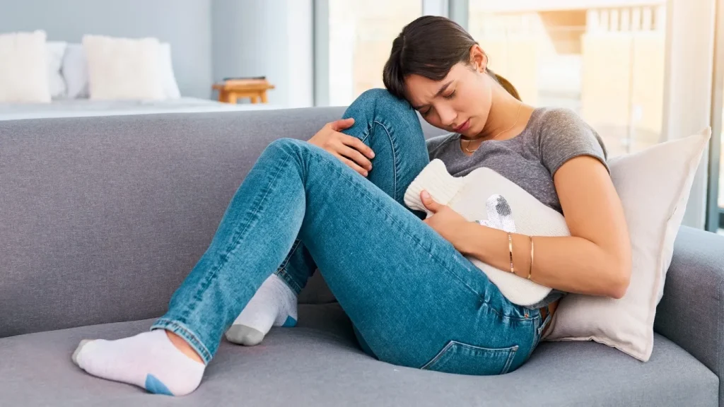Woman experiencing abdominal pain from PCOS and menstrual cramps